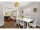 Bright dining room with hardwood floors, white furniture and seamless access to the living room at 200 Heaton Park Dr, Decatur, GA 30030