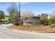 Stone sign and colorful flowers mark the entrance to Emory Village with lush green landscaping at 200 Heaton Park Dr, Decatur, GA 30030