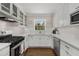 Well-lit kitchen featuring white cabinets, subway tile backsplash, and stainless steel appliances at 200 Heaton Park Dr, Decatur, GA 30030