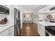 Open-concept kitchen flows into dining area and living room with stainless steel appliances at 200 Heaton Park Dr, Decatur, GA 30030