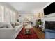 Bright living room with hardwood floors, plantation shutters, and seamless access to the dining room at 200 Heaton Park Dr, Decatur, GA 30030