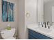 Charming half bathroom with blue vanity, gold fixtures, and a modern sink at 331 Parkview Manor Dr, Tucker, GA 30084