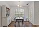 Bright dining area features wood floors, modern light fixture, and updated white cupboard for storage at 331 Parkview Manor Dr, Tucker, GA 30084