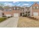 Charming townhome showcasing a brick facade, attached garage, and well-maintained front yard at 331 Parkview Manor Dr, Tucker, GA 30084