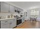 Modern kitchen with gray cabinets, stainless appliances, and eat-in dining space at 331 Parkview Manor Dr, Tucker, GA 30084