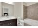 Bright bathroom featuring a vanity with a white countertop and a tiled shower over a tub at 3360 Camellia Ln, Suwanee, GA 30024