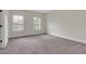 Bright bedroom with neutral carpeting and two windows allowing natural light at 3360 Camellia Ln, Suwanee, GA 30024