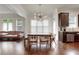 Dining area with hardwood floors and large window for natural light open to the living room at 3360 Camellia Ln, Suwanee, GA 30024