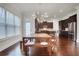 Eat-in dining area featuring hardwood floors, built-in benches, and views into the kitchen at 3360 Camellia Ln, Suwanee, GA 30024
