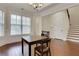 Cozy dining area featuring large windows, hardwood floors, and stairs at 3360 Camellia Ln, Suwanee, GA 30024