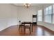 Bright dining room with hardwood floors, wainscoting, and large windows at 3360 Camellia Ln, Suwanee, GA 30024