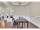 Charming dining space with dark table, hardwood floors, and view to living area at 3360 Camellia Ln, Suwanee, GA 30024