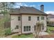 Exterior view of the home featuring windows, a dark roof, light siding, and partial landscaping at 3360 Camellia Ln, Suwanee, GA 30024