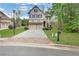 Beautiful home showcasing a well-maintained lawn, brick driveway, and a welcoming exterior at 3360 Camellia Ln, Suwanee, GA 30024