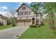 Charming brick home featuring a two-car garage, manicured lawn, and a classic, inviting facade at 3360 Camellia Ln, Suwanee, GA 30024