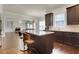 Open kitchen with granite counters, stainless appliances, and a view into the living room at 3360 Camellia Ln, Suwanee, GA 30024