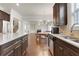 Kitchen with stainless steel appliances, granite countertops, and an open view to the living room at 3360 Camellia Ln, Suwanee, GA 30024