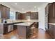 Modern kitchen features stainless steel appliances, granite countertops, and a center island with seating at 3360 Camellia Ln, Suwanee, GA 30024
