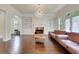 Inviting living room features hardwood floors, fireplace, and contemporary lighting at 3360 Camellia Ln, Suwanee, GA 30024