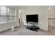Cozy living area featuring a television and large window at 3360 Camellia Ln, Suwanee, GA 30024
