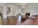 Open living room boasts hardwood floors, a cozy fireplace, and stairs to second level at 3360 Camellia Ln, Suwanee, GA 30024