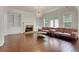 Bright living room with hardwood floors, built-in shelves, and stylish fireplace at 3360 Camellia Ln, Suwanee, GA 30024