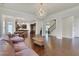 Spacious living room featuring hardwood floors, neutral paint, and an open floor plan to the kitchen at 3360 Camellia Ln, Suwanee, GA 30024