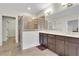 This main bathroom has double sinks, a shower, tile flooring, and is well lit at 3360 Camellia Ln, Suwanee, GA 30024