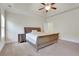 This main bedroom has neutral walls, beige carpet, ceiling fan, and is well lit at 3360 Camellia Ln, Suwanee, GA 30024