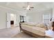 Spacious main bedroom with tray ceiling, carpet and ensuite bath access at 3360 Camellia Ln, Suwanee, GA 30024