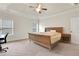 This main bedroom has neutral walls, beige carpet, ceiling fan, and is well lit at 3360 Camellia Ln, Suwanee, GA 30024