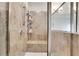 This main bathroom has a large glass shower with a bench and lots of tile at 3360 Camellia Ln, Suwanee, GA 30024