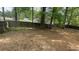 Fenced backyard featuring shade trees and patchy grass at 100 Waters Edge Dr, Locust Grove, GA 30248