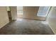 Spacious bedroom featuring neutral walls, carpet floors, and natural light from windows at 100 Waters Edge Dr, Locust Grove, GA 30248