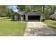 Modest single-story home with damaged garage and well-maintained front lawn at 100 Waters Edge Dr, Locust Grove, GA 30248