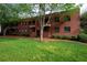 Brick apartment building with lawn, a tree, and neatly trimmed shrubs at 1380 Chalmette Ne Dr # 3, Atlanta, GA 30306