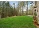 Lush backyard with green grass, mature trees, and manicured landscaping, ideal for outdoor enjoyment at 3892 Trillium Wood Trl, Snellville, GA 30039