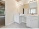 Bathroom featuring double sinks with granite countertops, vanity lighting, and a spacious mirror at 3892 Trillium Wood Trl, Snellville, GA 30039
