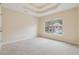 Empty bedroom offers carpet floor and large windows to view the surrounding area at 3892 Trillium Wood Trl, Snellville, GA 30039