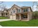 Well-maintained two-story home with a lush green lawn and a two-car garage at 3892 Trillium Wood Trl, Snellville, GA 30039