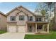 Charming two-story home with a two-car garage and a welcoming front porch at 3892 Trillium Wood Trl, Snellville, GA 30039
