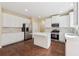 Kitchen features white cabinets, stainless steel appliances, and center island at 3892 Trillium Wood Trl, Snellville, GA 30039