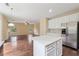Open kitchen view features stainless steel refrigerator and a center island at 3892 Trillium Wood Trl, Snellville, GA 30039