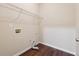 Functional laundry room with hardwood floors, wire shelving, and easy access to utilities at 3892 Trillium Wood Trl, Snellville, GA 30039