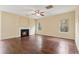 Bright living room features hardwood floors, fireplace and a ceiling fan at 3892 Trillium Wood Trl, Snellville, GA 30039