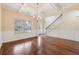 Open-concept living room featuring hardwood floors, large windows, and stylish design at 3892 Trillium Wood Trl, Snellville, GA 30039