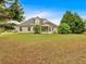 Wide backyard features mature trees, a screened-in porch, and a white picket fence at 57 Craig Meadows Ln, Douglasville, GA 30134