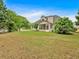 Expansive backyard featuring mature trees and a screened-in porch at 57 Craig Meadows Ln, Douglasville, GA 30134