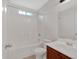 Well-lit bathroom with bathtub, shower, and vanity with dark wood cabinet at 57 Craig Meadows Ln, Douglasville, GA 30134