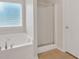 Bright bathroom featuring a soaking tub with jets and a glass shower at 57 Craig Meadows Ln, Douglasville, GA 30134